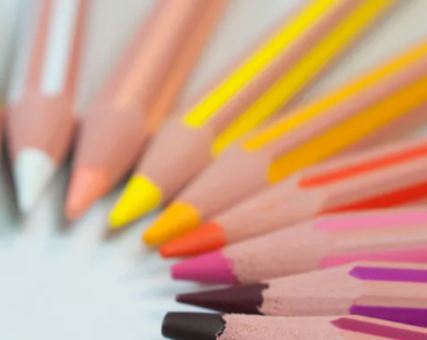 Colourful rainbow pencils laid out in a circle.